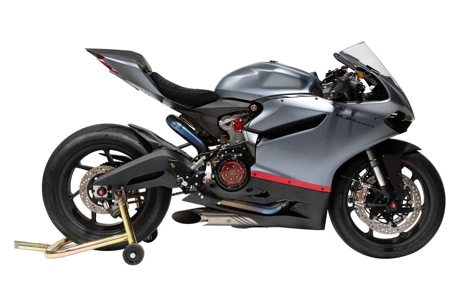 high performance sport motorcycle in metallic grey sits on a rear paddock stand with exposed clutch cover