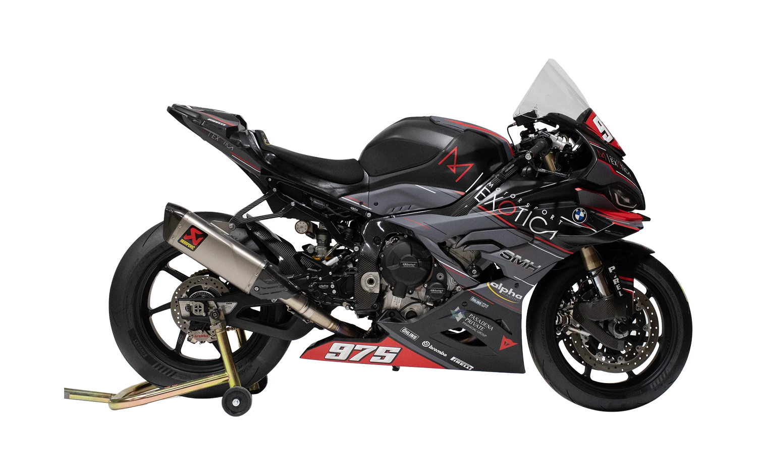 Track-ready BMW sportbike on paddock stand with racing number, carbon fairings, and Akrapovič exhaust